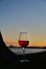glass of red wine at sunset