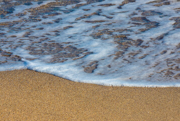a small wave on the sand