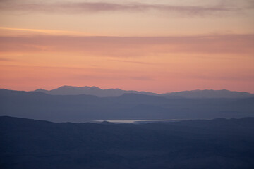 sunset over the west desert with the mountains of utah and Nevada in the distance