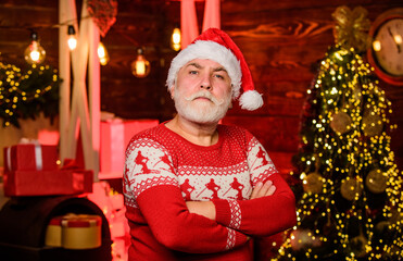 Obraz na płótnie Canvas in bad mood. bearded man santa hat. merry christmas. cheerful santa man red sweater. happy new 2020 year. warm clothing in cold season. xmas gifts and presents. winter holiday. party time