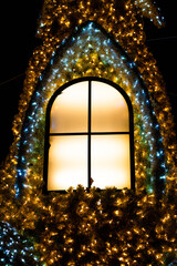 The window to a fairytale house decorated for Christmas