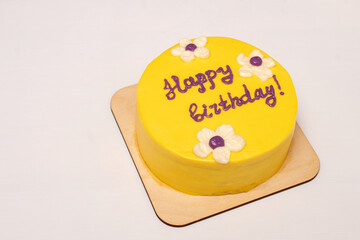 Yellow bento cake with the inscription Happy Birthday. White background with place for text....