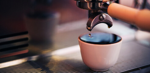 Selective focus,Close-up of black coffee or cappuccino hot poured from a professional brewing...