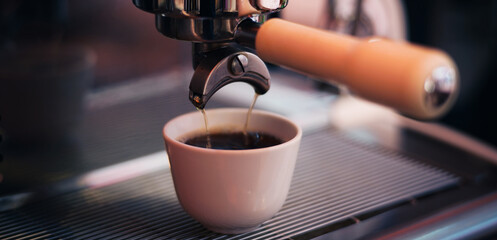 Selective focus,Close-up of black coffee or cappuccino hot poured from a professional brewing...