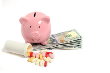 Pills, piggy bank and lot money on white background, concept expensive medicine and medicines.