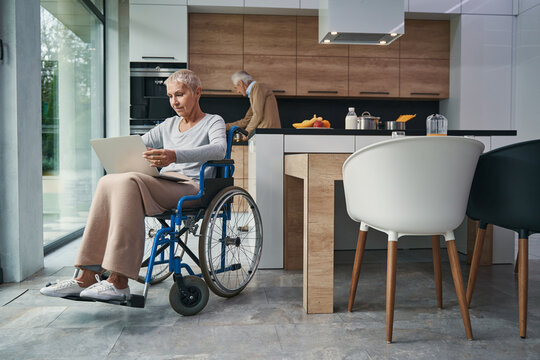 Pleased disabled woman working at her computer