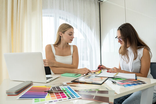 Two female designers working with house paln and color palette, interior design