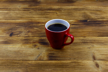 Cup of coffee on the wooden table