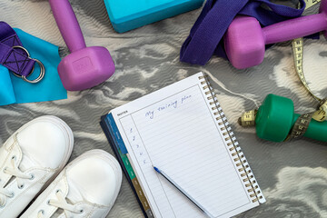 top view of new athletic equipment and notebook with pen.