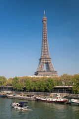Fototapeta na wymiar Paris with Eiffel Tower against boats during spring time in France
