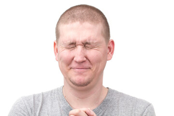 Obraz premium A man showing a facial expression, bursting out in laughter on a white background. 