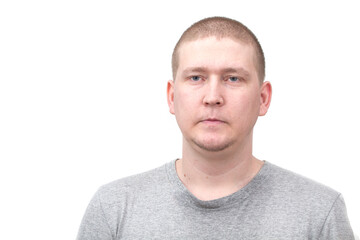 A young man looking disgusted in front of a white background. 