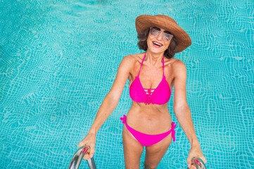 Happy senior woman at the swimming pool