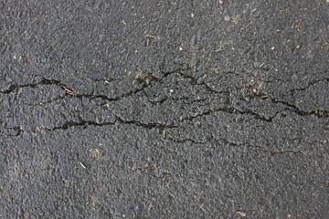 road asphalt texture that breaks due to vehicle vibrations that pass through the load capacity of the asphalt
