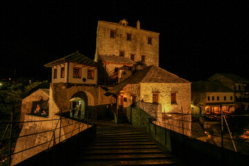 Famous rebuilt historic bridge in downtown Mostar at night