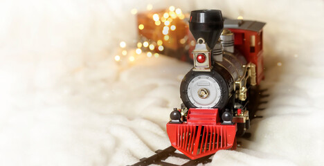 A festive Christmas train rides on a light background