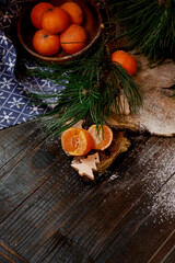 Christmas background with wooden board and tangerines. There is copy space for text in the photo.