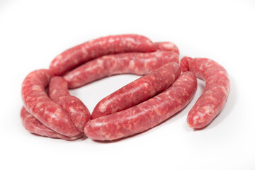 Many crude sausages on a white background