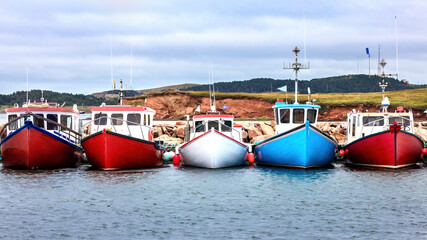 A row of colour fishing boats in the harbour of Havre Aubert, Magdalen Islands, Canada.