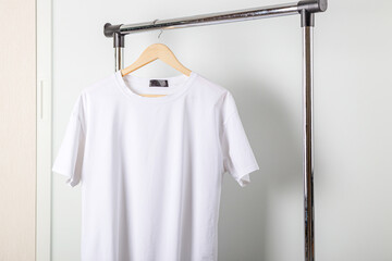 White t-shirt mockup on clothes hanger. Bella canvas mock up in minimal style.