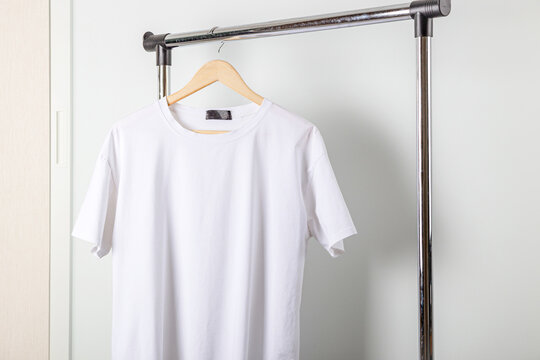 T-shirts Hanging On Hangers Isolated On White Background Stock Photo,  Picture and Royalty Free Image. Image 25922639.