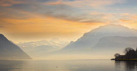 The landscape of  mountain lake in the morning at Swiss Alps. Breathtaking Scene with sunset sky scene as the Panoramic view of beautiful mountain landscape in Alps background