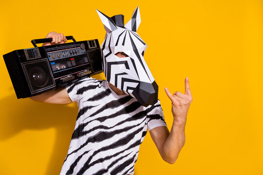 Photo Of Weird Freak Guy Dj In Zebra Mask Hold Boom Box Song Show Horned Fingers Isolated Over Bright Yellow Color Background