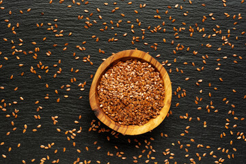Source of vitamins groups B, fiber, Omega 3, potassium, magnesium and antioxidants - flax seeds on the surface of the slate with