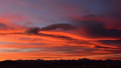 summer sunset over the front range of the rocky mountains as seen from broomfield, colorado