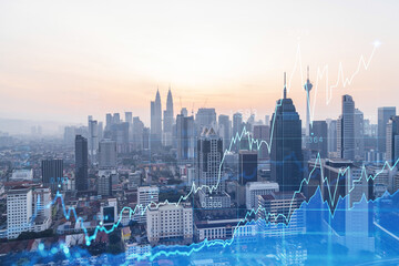 Glowing FOREX graph hologram, aerial panoramic cityscape of Kuala Lumpur at sunset. Stock and bond...