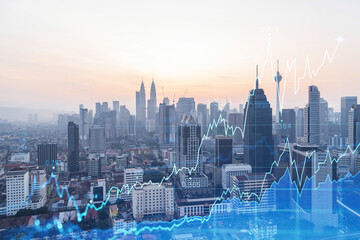 Glowing FOREX graph hologram, aerial panoramic cityscape of Kuala Lumpur at sunset. Stock and bond trading in KL, Malaysia, Asia. The concept of fund management. Double exposure.