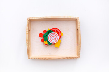 Montessori material is wooden. Toddler education concept. Eco friendly toy. Food for playing chef