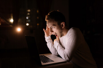 Worried stressed man shocked using laptop at work, angry lost mo