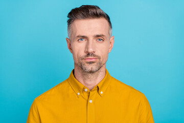 Portrait of attractive content serious man wearing formal shirt isolated over bright blue color background
