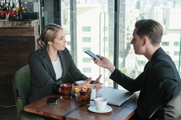 Two businessman and businesswoman couple meeting in co working space or office