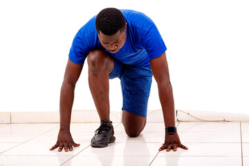 handsome sporty young man getting ready to run.