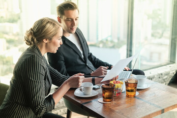 Two businessman and businesswoman couple meeting in co working space or office