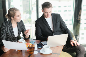 Two businessman and businesswoman couple meeting in co working space or office