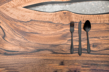 Black cutlery on a luxurious wooden table
