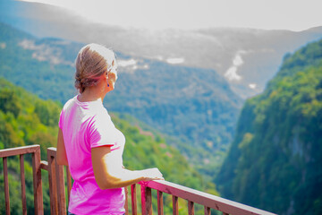 Fototapeta na wymiar girl on the observation deck of okatse canyon