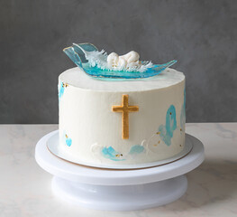 cake for the baptism of a child. little baby chocolate cake decor and golden cross
