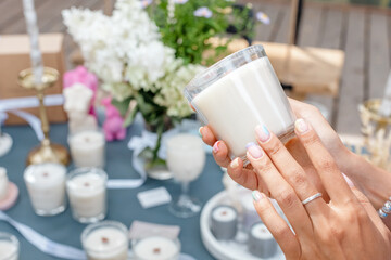 Girl chooses an aroma candle in the store. Creating a relaxing mood