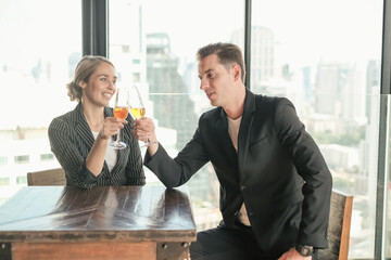 Two businessman and businesswoman couple meeting in co working space or office