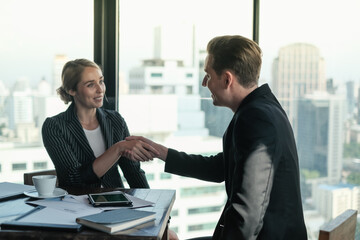 Two businessman and businesswoman couple meeting in co working space or office