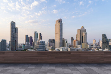 Fototapeta premium Panoramic Bangkok skyline view, concrete observatory deck on rooftop, sunset. Luxury Asian corporate and residential lifestyle. Financial city downtown, real estate. Product display mockup empty roof