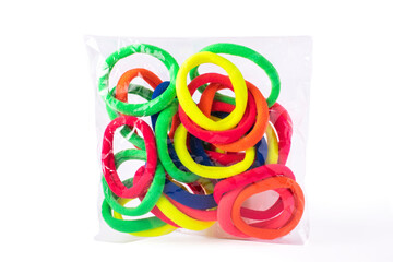 Bright, neon elastic hair .in transparent packaging on white isolated background.
