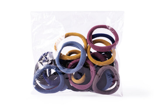 Multicolored elastic hair .in transparent packaging on white isolated background.