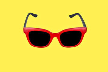 Red sunglasses in a yellow background