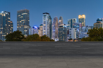 Panoramic Bangkok skyline view, concrete observatory deck on rooftop, night time. Asian corporate...