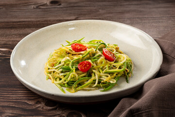 Zucchini spaghetti with tomatoes in garlic and oil.